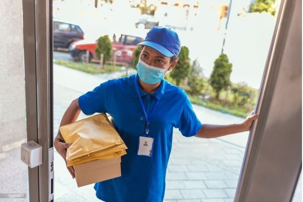 Delivery boy wear blue shirt with parcel